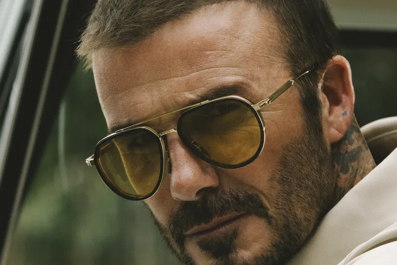 David Beckham wearing gold aviator sunglasses in the Eyewear by David Beckham campaign