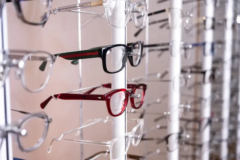 A Gucci frame with the green-and-red web stripe temple on the display rack