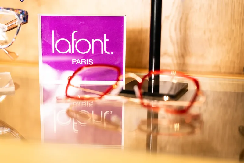 The Lafont Paris counter sign beside a pair of red Lafont frames