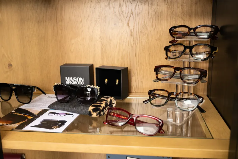 Crystal-trimmed Maison Sekimoto sunglasses beside the brand box in the cabinet