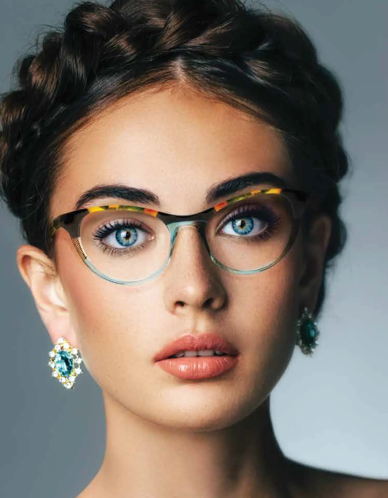 Colorful Dolabany cat-eye frames on a woman with braided hair and blue eyes