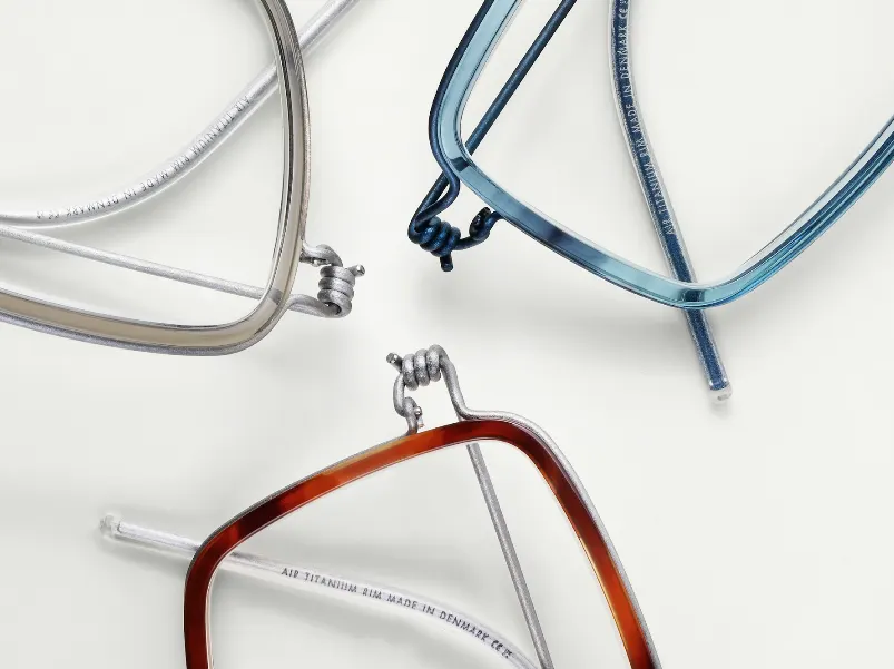 Three Lindberg Air Titanium rim frames laid out on a light tabletop