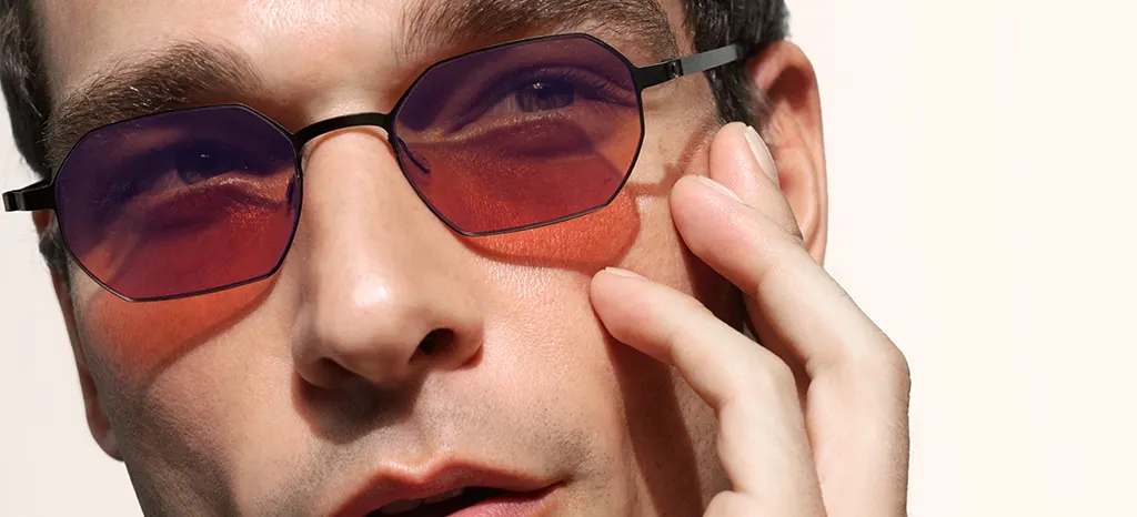 Man wearing octagonal Lindberg sunglasses with amber lenses