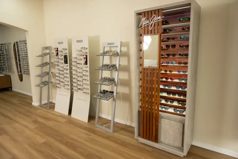 Maui Jim lighted sunglasses tower next to the MODO frame stands